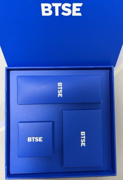 A blue BTSE branded merchandise box containing several blue BTSE-branded product boxes inside.