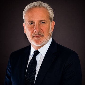 A formal portrait of Peter Schiff, the same economist who is quoted in the accompanying post expressing concerns about Bitcoin.