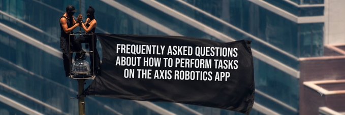 Two masked individuals unfurl a large black banner reading "FREQUENTLY ASKED QUESTIONS ABOUT HOW TO PERFORM TASKS ON THE AXIS ROBOTICS APP" against the backdrop of a glass skyscraper. The dramatic protest-style banner visually reinforces the post's thread explaining how to complete Axis Robotics tasks in anticipation of the $AXIS TGE airdrop.