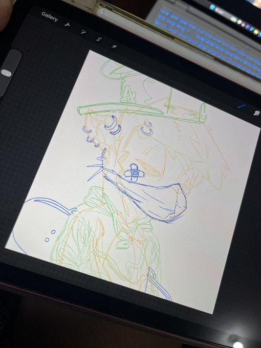 A digital tablet displaying a rough sketch of an anime-style character with green hair and a hat, with a backlit keyboard visible in the background.