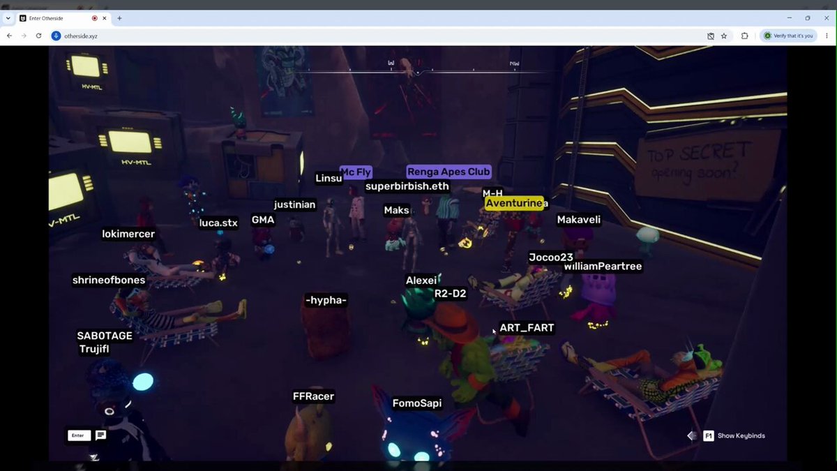 The image shows a group of people gathered together, with some standing and others sitting or lying down. The scene appears to be set in a virtual environment where players are engaged in a game. One person's head is turned towards another player who is located near them. This suggests that they might be discussing strategies or reacting to an event within the game. The focus on this individual could indicate their importance or involvement in the ongoing activity, and it may also provide insight into how people interact with each other while playing games together.