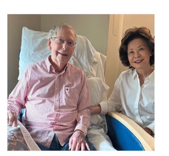 An elderly couple poses together in a hospital setting, with the man propped up in a hospital bed wearing a pink checkered shirt and the woman seated beside him in a white blouse.

The image humorously illustrates the meme's theme of waiting an extraordinarily long time to see a financial milestone achieved—comparing the years-long wait for the man to leave the hospital bed to the impossibly distant 2076 target date for ETH to reach $2500.