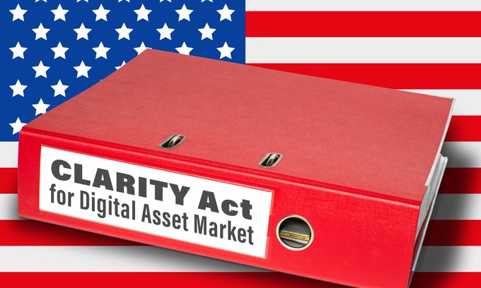 A red binder labeled "CLARITY Act for Digital Asset Market" sits against an American flag background.