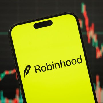 A smartphone displaying the Robinhood app logo against a dark background featuring a red candlestick chart.