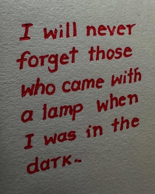 Handwritten red text on textured background reading: 'I will never forget those who came with a lamp when I was in the dark.'