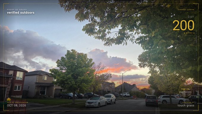 A suburban street scene at sunset framed by tree leaves, with overlay text reading 'PROOF OF GRASS verified outdoors', 'DAY 200', 'CURRENT STREAK', and 'STREAK ENDS ON OCT 06, 2026'.