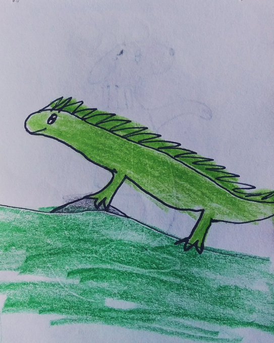 A child's crayon drawing of a green iguana with a spiky crest standing on a green grassy hill against a light blue background.