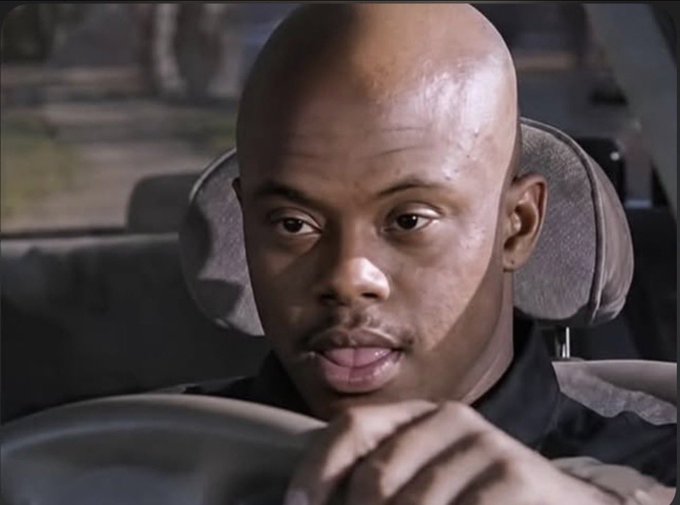 A serious-looking bald man sits in the driver's seat of a car, staring straight ahead with a calm, resolute expression. His contemplative demeanor visually conveys the certainty behind the post's declaration to "delete the FOMO app."