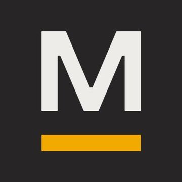 The image displays a bold white letter "M" with an orange underline on a black background, serving as the Marathon Digital Holdings (MARA) logo that represents the company featured in the post about pledging 18,750 BTC to secure $600 million in loans for energy and AI infrastructure expansion.