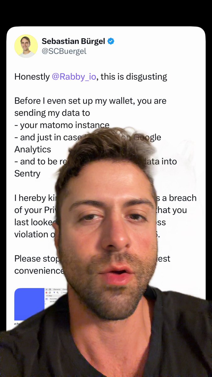 In this image, a man with a beard is seen wearing a black shirt, looking at his phone screen. The screen displays a message from someone named "Rabbby" who wrote about a curse affecting their wallet. The message also mentions that the wallet is not affected by the curse and encourages the user to focus on what's in front of them instead of worrying about the curse.