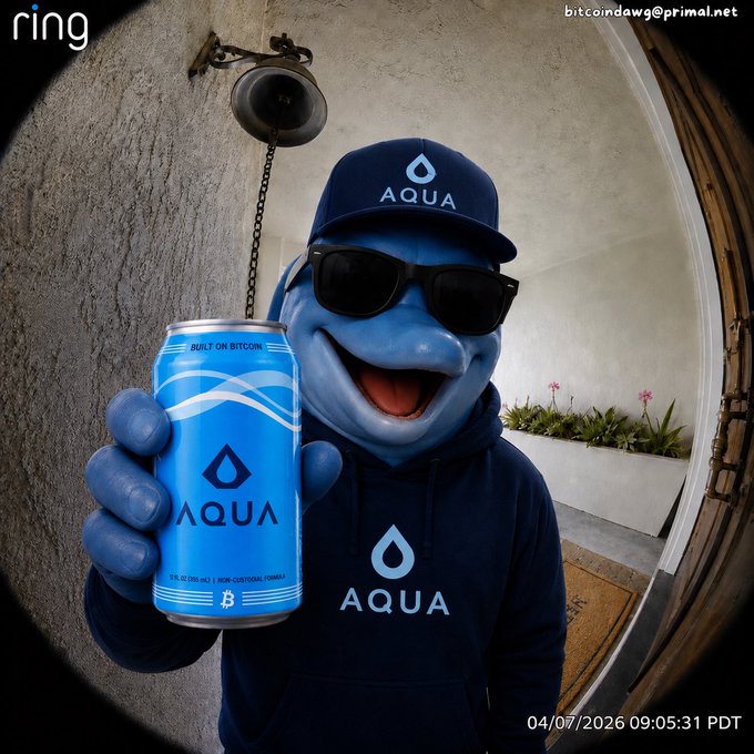 The image features a man wearing sunglasses, a blue hoodie with "aqua" written on it, and holding a can of Aquafina water. The caption for the image reads: "I’ll have what he's having #StaySovereign #AQUA #Bitcoin". This suggests that the man is promoting or supporting the brand Aquafina while wearing sunglasses and a blue hoodie with the word "aqua" on it, possibly as part of an advertisement.