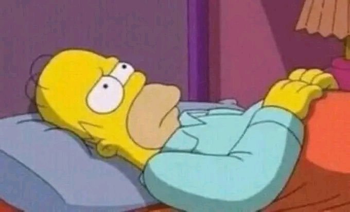 A still from The Simpsons showing Homer Simpson wide awake in bed with a worried expression.