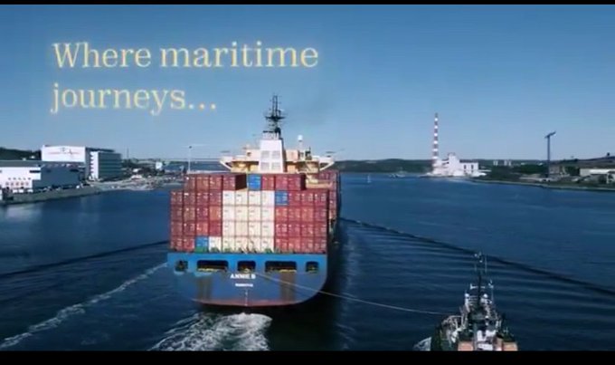 Aerial footage of a large container ship being escorted by a tugboat through a harbor, with the text 'Where maritime journeys...' overlaid.