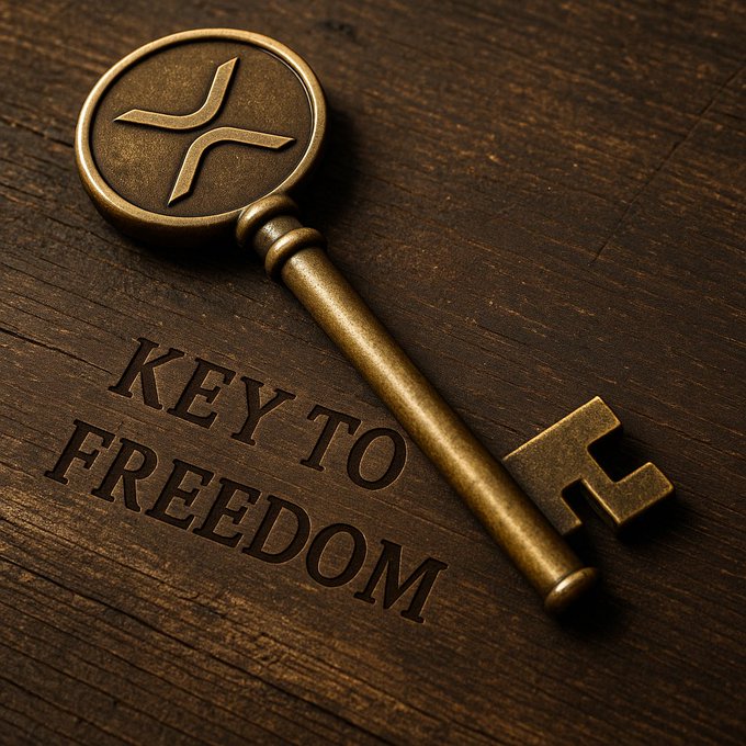 An ornate brass key featuring the XRP logo on its bow rests on a wooden surface alongside the engraved phrase "KEY TO FREEDOM," visually reinforcing the post's metaphor of XRP as a gateway to financial liberation.