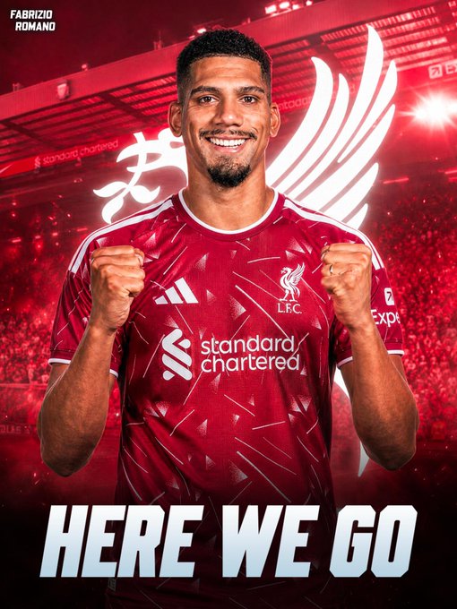 A smiling player in a red Liverpool FC jersey (L.F.C) poses with clenched fists under stadium lights, with the "HERE WE GO" transfer announcement text and "FABRIZIO ROMANO" credit in the corners, celebrating the club's new signing.