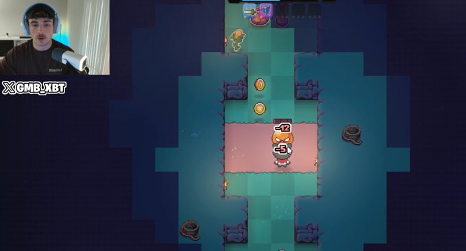 A gamer wearing headphones streams a top-down roguelike game where a character with "-12" and "-5" damage indicators fights enemies in a tiled arena, while the channel watermark "XCMBXBT" appears in the corner—matching the creator's post about getting their upgraded streaming setup back and teasing upcoming crypto/DeFi guides from their gaming stream.