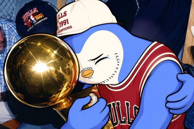 The image shows an anthropomorphic blue penguin mascot (Benny the Bull) wearing a Chicago Bulls jersey and a championship cap reading "BULLS 1991 World Champions," hugging the golden Larry O'Brien NBA championship trophy, while "1991 CHAMPIONS" appears on another cap in the background.

The post uses this image of the Bulls mascot celebrating a championship to signal confidence and victory, suggesting the poster is feeling like a "winner" as they greet 38,000 followers and solicit reply interactions with a $38 ($SOL) tip.