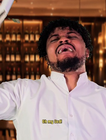 A man with curly hair and a beard stands in front of a wine shelf, tilting his head back with his eyes closed and mouth open in an expression of shock or distress. The caption "Oh my God" appears at the bottom of the image, humorously matching the post's joke about a Litecoin transaction with an exaggerated reaction face.