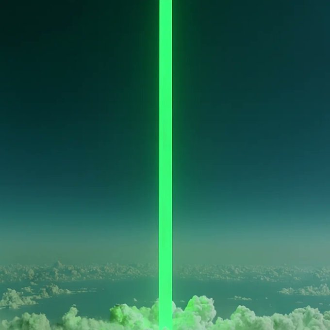 A bright green laser beam shooting straight up into a dark sky from above a layer of clouds.