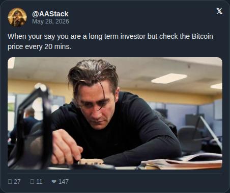 The image shows a man sitting next to a computer desk with his hand on a keyboard and laptop screen in front of him. The background includes other people, desks, and chairs, giving an office-like setting. Below the main photo, there is a Twitter post featuring a caption about investing in Bitcoin that reads: "When your say you are a long-term holder but check the price every 20 minutes No judgment - just be honest with yourself Your future self doesn't care about today's candle ... Repeat BTC at $73,548 - overheated zone on the power law Track the cycle →".
