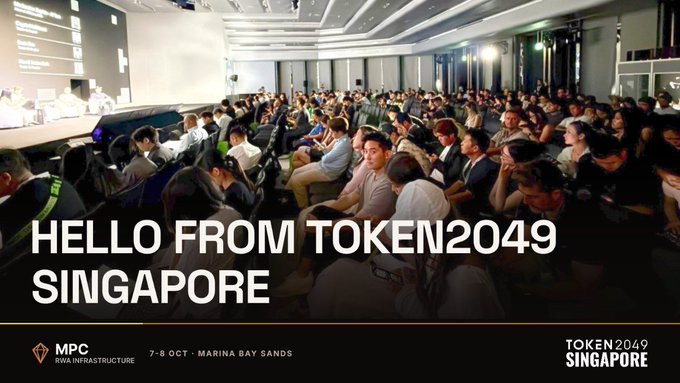A conference audience scene with the text overlay 'HELLO FROM TOKEN2049 SINGAPORE' and details indicating the event is held at Marina Bay Sands on 7-9 Oct.