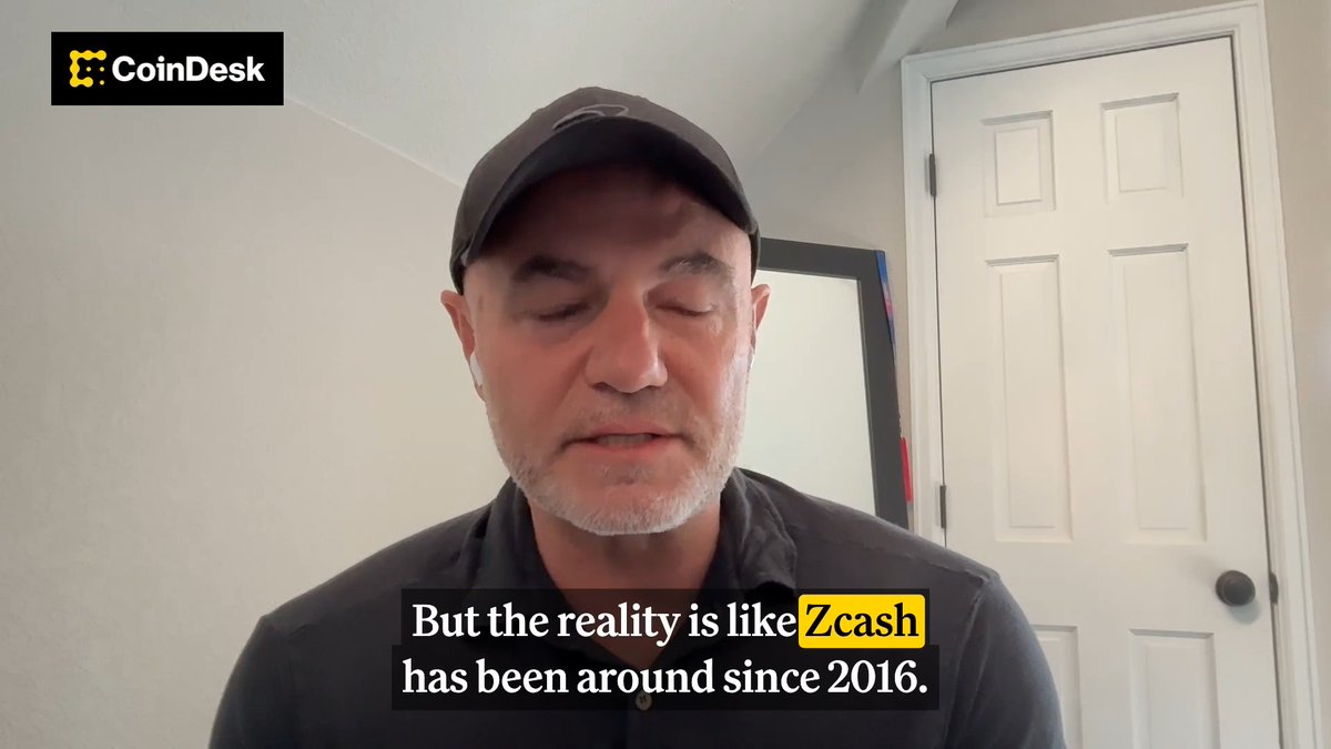 The image features a man wearing a black shirt with white text on it, who appears to be talking about Bitcoin or Zcash. The man has his eyes closed and looks thoughtful as he speaks. There are also some numbers visible in the image that seem to be related to the conversation.