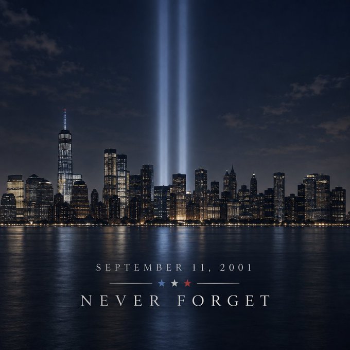 The New York City skyline at night with two vertical light beams rising from the former site of the World Trade Center, captioned "SEPTEMBER 11, 2001 — NEVER FORGET." The commemorative Tribute in Light serves as a solemn visual tribute, aligning with the message honoring those affected by the attacks.