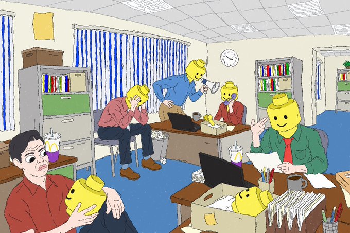 An illustration of an office scene where the only non-Lego Minifigure employee, a realistic man in a red shirt, looks disheveled and exhausted while holding a yellow Lego head. His coworkers, all standard yellow Lego minifigures, appear happy and engaged in their work at desks equipped with laptops and McDonald's drinks.