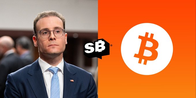 A man in glasses and a blue tie appears next to the SB (SportsBlock) logo and an orange Bitcoin logo.