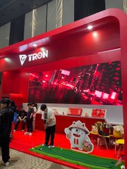 Photo of a red 'TRON' branded booth/stand setup at what appears to be a public event or exhibition.
