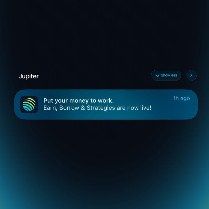 Dark-themed app notification from Jupiter announcing that 'Put your money to work. Earn, Borrow & Strategies are now live!' posted 1 hour ago.