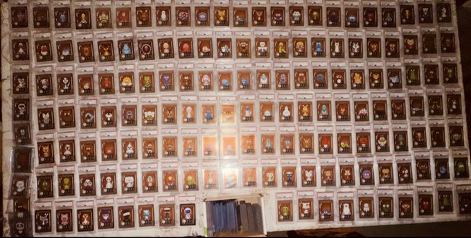 A wall display features dozens of Veefriends trading cards arranged in a grid, each sealed in protective plastic cases with a label underneath, showcasing the rare collectible set offered for sale.