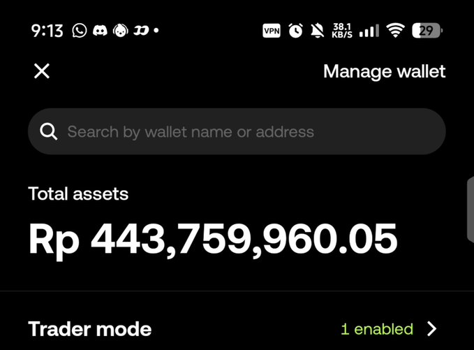 A screenshot of a "Manage wallet" screen showing total assets of Rp 443,759,960.05, with Trader mode set to "1 enabled," illustrating the poster's hope to strike it rich in memecoin trading.