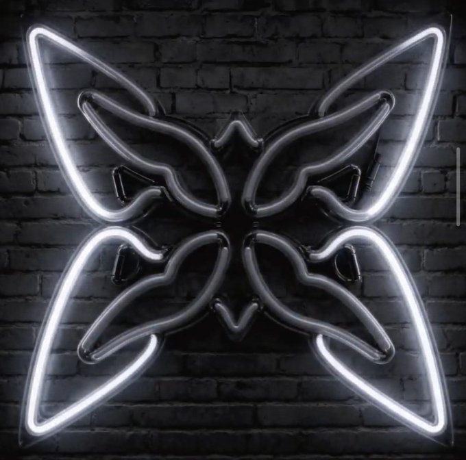A glowing white neon light shaped like a butterfly mounted on a dark brick wall.