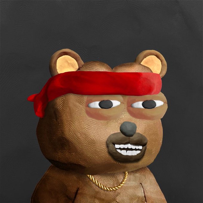 A 3D render of a brown teddy bear character wearing a red headband and a gold chain necklace against a dark gray background.