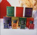 A small product display showing several colorful perfume boxes and bottles in shades of green, red, blue, and gold arranged together.