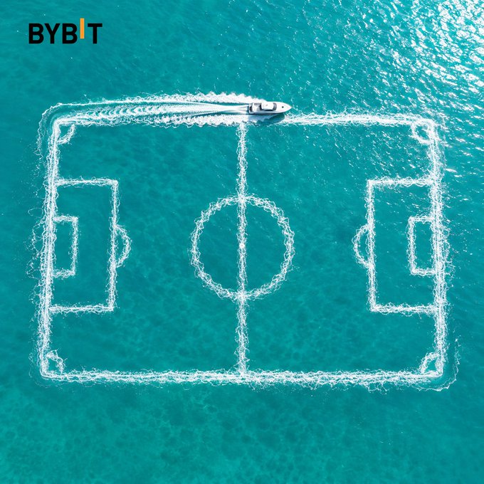 An aerial view of a boat creating a soccer field pattern with its wake in turquoise water, branded with the 'BYBIT' logo in the top left corner.