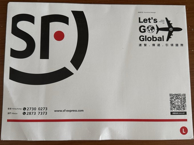 A large white shipping envelope from SF Express with the SF logo and a 'Let's GO Global' promotional message in Hong Kong and Macau.