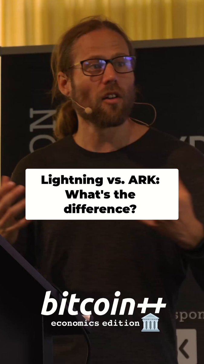 The image features a man wearing glasses standing next to a sign that reads "Lightning vs Ark" with a caption below it stating "What's the difference?". The man appears to be giving a speech or presentation, possibly at an event related to Bitcoin or another topic.