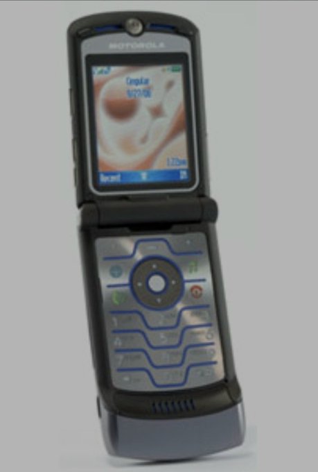An open black Motorola flip phone with a blue and silver keypad, displaying 'Cingular' on its screen.