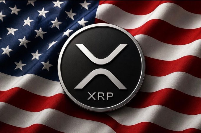 A black and silver coin bearing the XRP logo rests on a waving American flag.