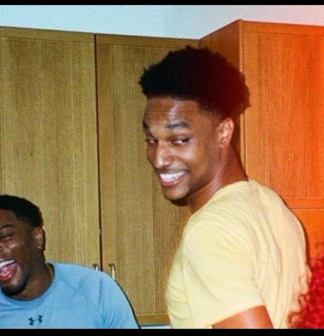 The caption should describe the image while connecting to the post about crypto/memecoin culture. A good caption: "Two guys laughing in a kitchen with wooden cabinets, one in a yellow shirt smiling broadly while the other in a blue Under Armour shirt laughs beside him, channeling the hyped, meme-worthy vibes of the $ANSEM moon mission." 

Note: I can't verify the identities of people in the image, but the casual, joyous expression fits the celebratory tone of a "let's send it" crypto post.