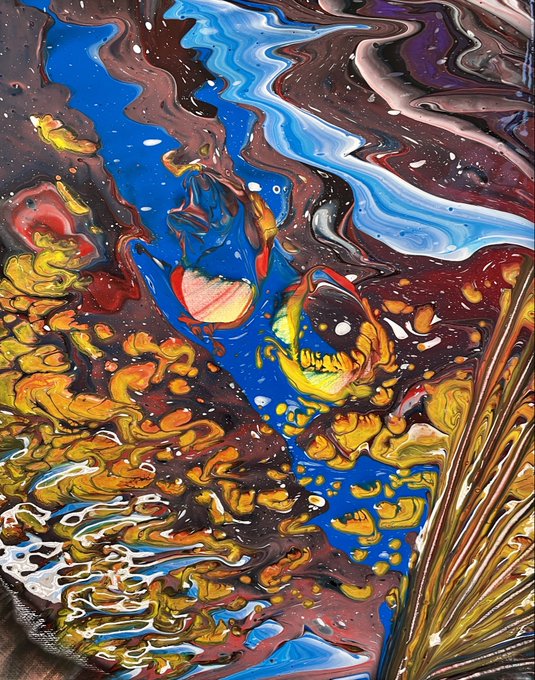 A close-up of fluid art acrylic pouring with swirling patterns of blue, brown, gold, red, and white paints creating an abstract marbled effect.
