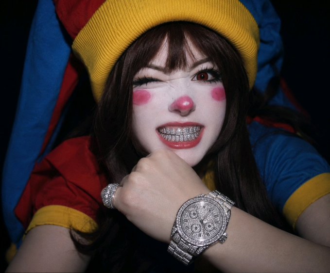 A woman in colorful clown-like makeup and a jester hat winks while showing off diamond-encrusted grills and a flashy jeweled watch, embodying the bold, tongue-in-cheek confidence behind the $Clussy stock pump post. The flashy jewelry and playful expression match the meme's "diamond hands" energy and humorous promise of gains in October.