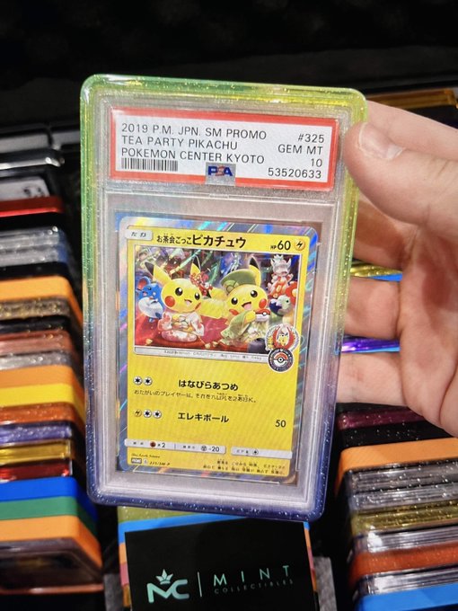A hand holding a graded PSA 10 '2019 PM JPN SM PROMO TEA PARTY PIKACHU GEM MT' Pokémon card (cert #53520633) from Pokémon Center Kyoto, displayed above a Mint Collectibles box.