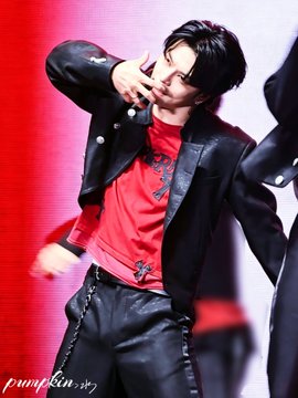 A K-pop idol performs on stage wearing a black jacket over a red shirt and black leather pants, with the watermark 'pcyin_07' visible.