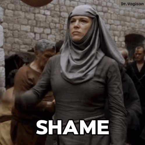 The image features a woman dressed in medieval clothing, standing against a brick wall with her arms outstretched. The caption below the image reads "Shame", which seems to be a reference to the character's actions or behavior from a previous scene.