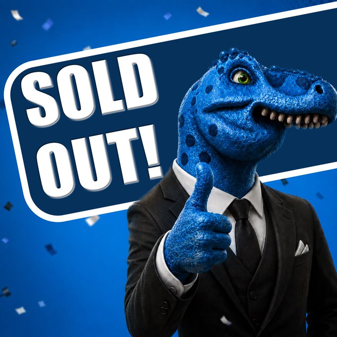 A blue dinosaur in a business suit gives a thumbs up in front of a 'SOLD OUT!' sign with blue confetti falling.