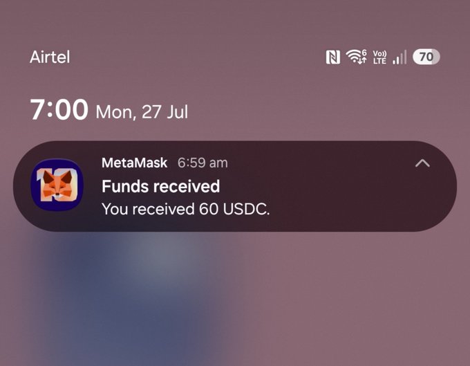 A smartphone lock screen notification from MetaMask showing "Funds received: You received 60 USDC" at 6:59 am on Monday, July 27.