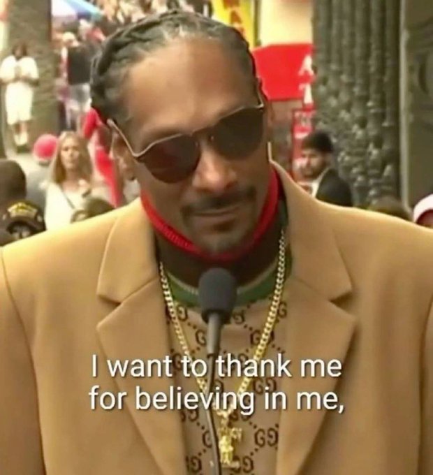 Snoop Dogg wearing sunglasses and a Gucci sweater speaks into a microphone, with subtitles reading, 'I want to thank me for believing in me,'.
